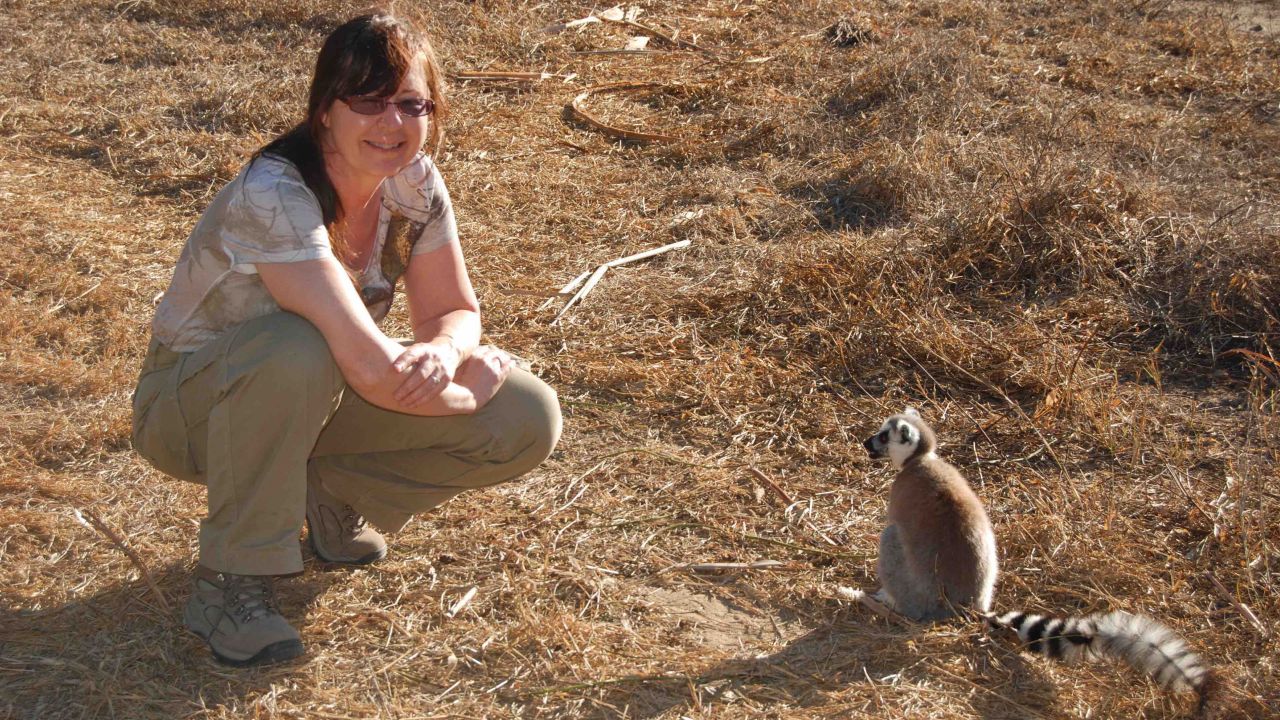 Michelle Sauther poses next to a ring-tailed lemur.
