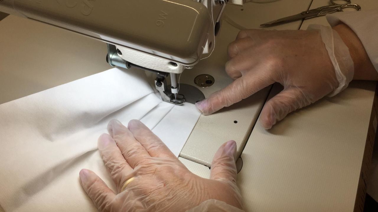 A mask being machine-sewn at a Prada factory in Tuscany, Italy