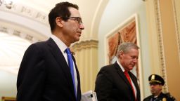 Treasury Secretary Steven Mnuchin, left, and acting White House chief of staff Mark Meadows walk to the offices of Senate Majority Leader Mitch McConnell of Ky. on Capitol Hill in Washington, Tuesday, March 24, 2020. 