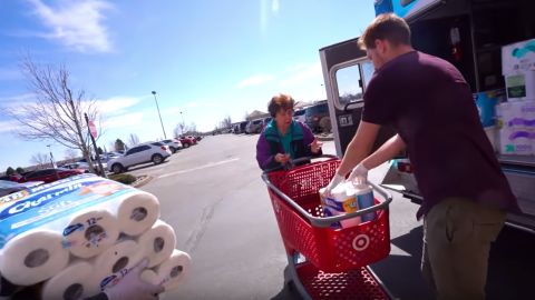 Scites fills a stranger's shopping cart with toilet paper from his YouTube channel's repository.