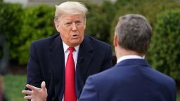 US President Donald Trump (L) speaks with anchor Bill Hemmer during a Fox News virtual town hall meeting from the Rose Garden of the White House in Washington, DC, on March 24, 2020.