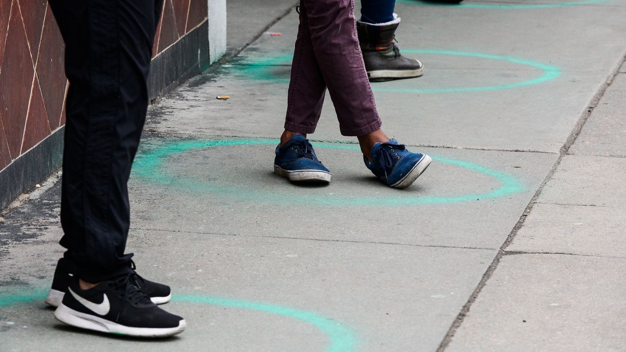 People stand in freshly painted circles, six-feet-apart, as they wait in a two-hour line on March 23, 2020 in Denver, Colorado.