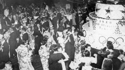 TA36M0 View over the dancing guests of a Christmas party in Tokyo. On the right is a large cake with the inscription 1940 XII Olympiad Tokyo, to celebrate the upcoming Olympics in Japan.