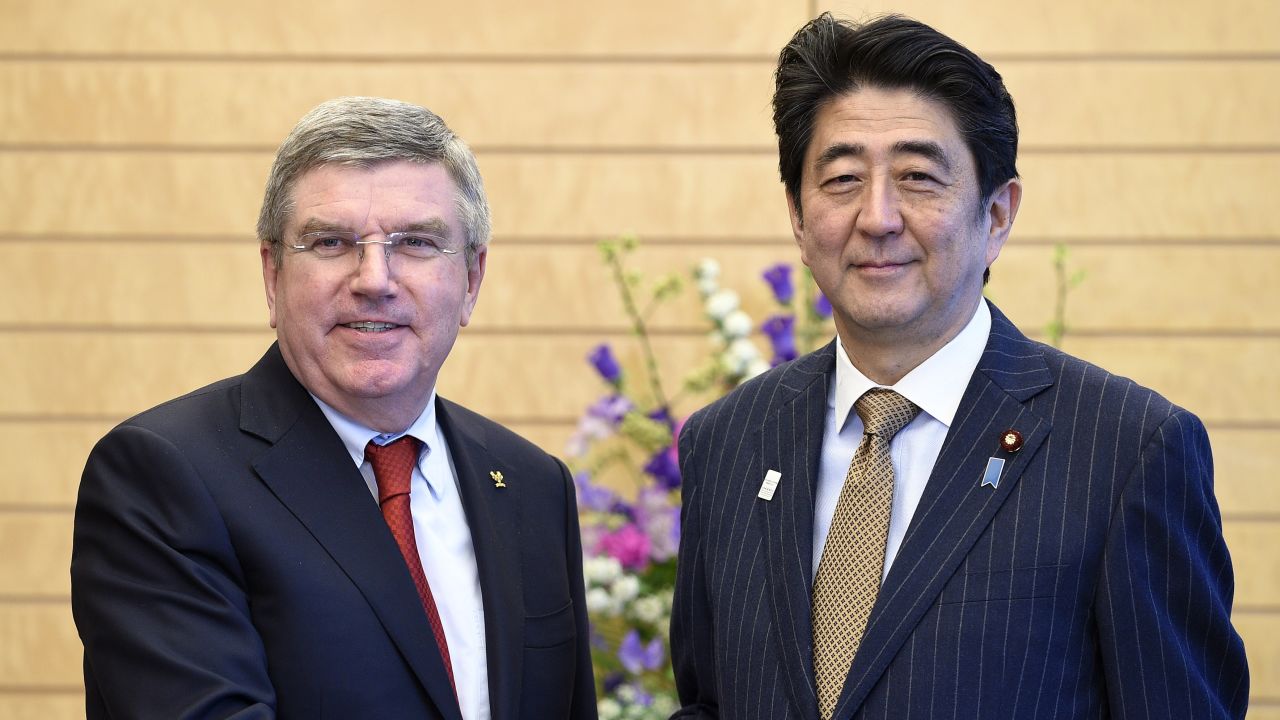 International Olympic Committee (IOC) President Thomas Bach (L) and Japanese Prime Minister Shinzo Abe shake hands prior to their meeting at Abe's official residence in Tokyo on March 13, 2015. 