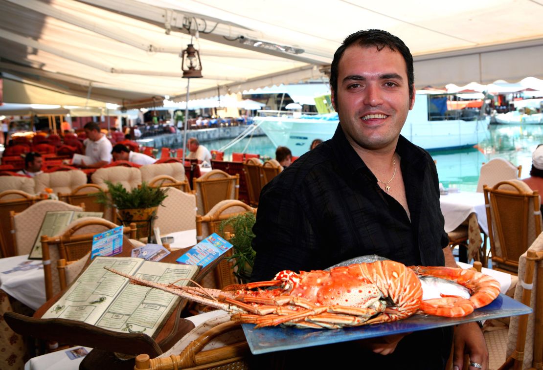 Greece will still be offering warm welcomes... and delicious seafood... when the crisis is over. 