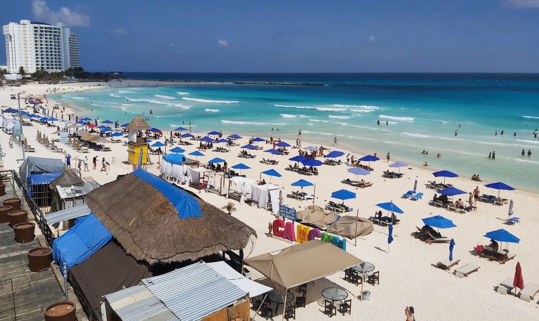People enjoy a day at the beach in Cancun, Mexico, over the weekend, despite the coronavirus pandemic.