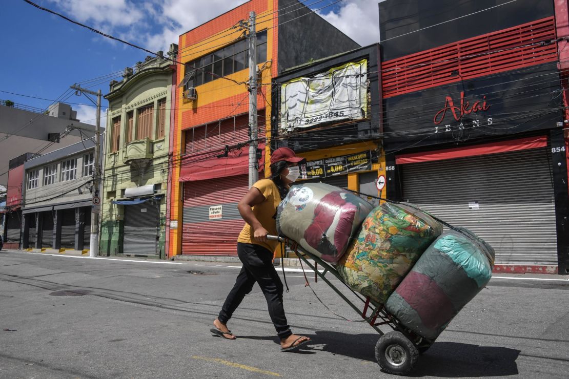 A street vendor walks along an empty popular shopping street in downtown Sao Paulo during its lockdown.