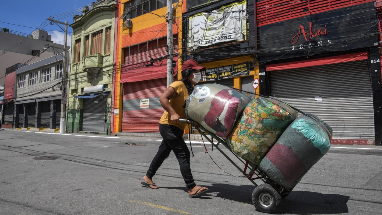 A street vendor walks along an empty street in downtown Sao Paulo, Brazil, on Tuesday.