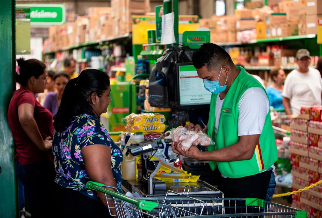 A cashier wears a face mask at a supermarket in Managua, Nicaragua. 