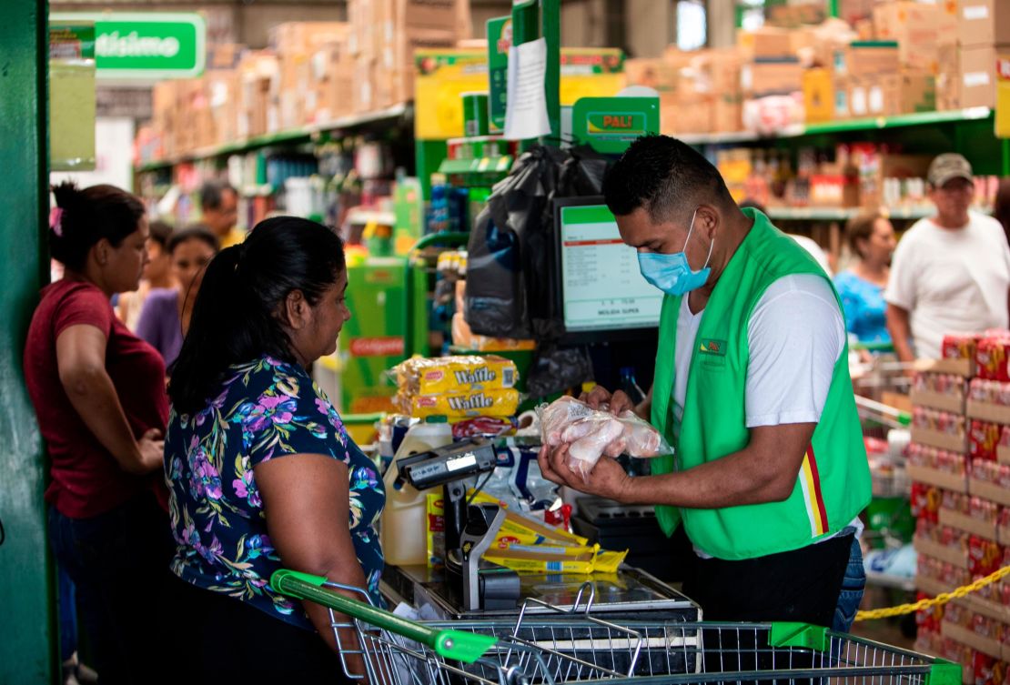 A cashier wears a face mask at a supermarket in Managua, Nicaragua.