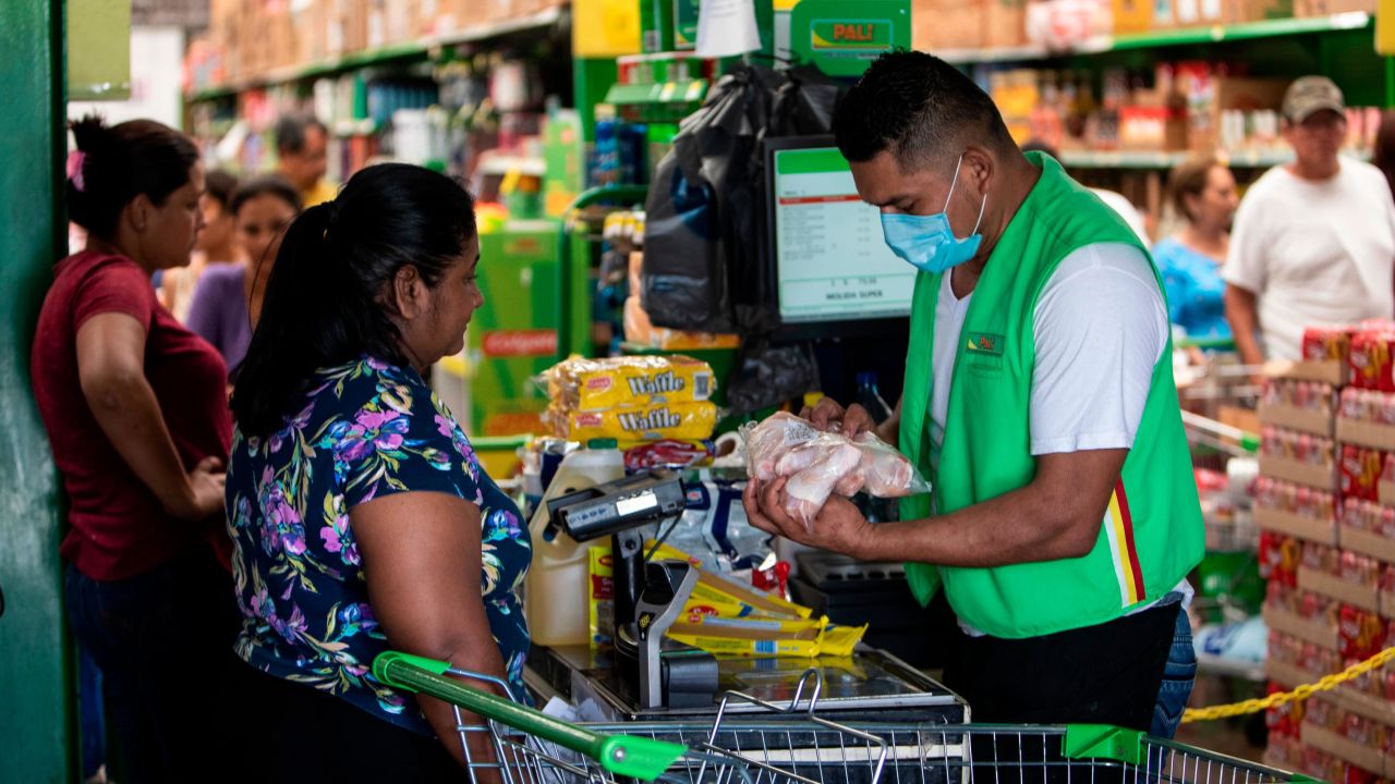 A cashier wears a face mask at a supermarket in Managua, Nicaragua. 