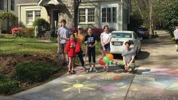 About a dozen families came together to do something special at each stop on 16-year-old Carrie Crespino's birthday walk through her Decatur, Georgia neighborhood.