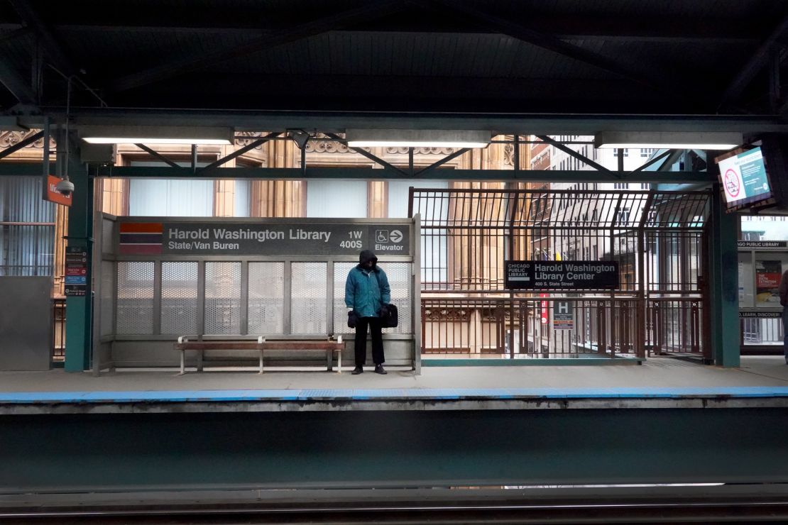 A lone commuter waits for an "L" train during rush hour in Chicago on March 20.