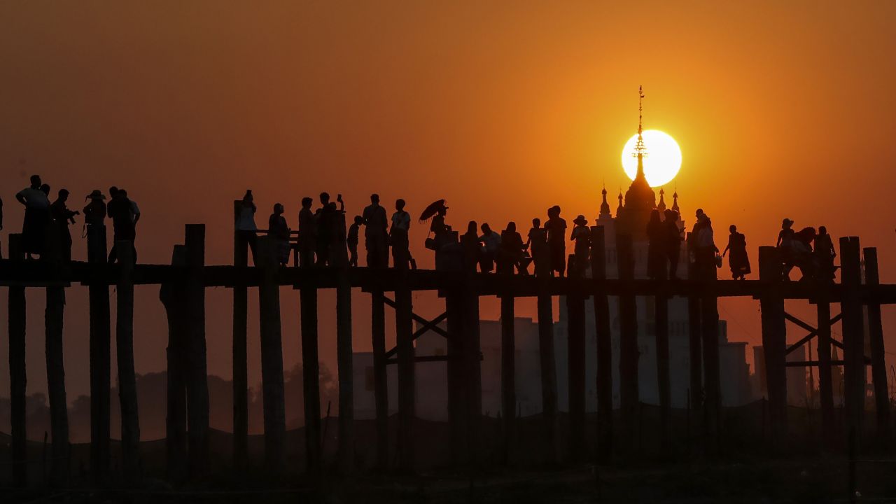 <strong>Mandalay, Myanmar:</strong> On March 11, visitors walk along the wooden U Bein Bridge that connects the two banks of Taungthaman Lake. 