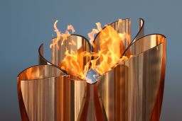 The Olympic cauldron is lit during the 'Flame of Recovery' special exhibition at Aquamarine Park a day after the postponement of the Tokyo 2020 Olympic and Paralympic Games.