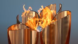IWAKI, JAPAN - MARCH 25: The Olympic cauldron is lit during the 'Flame of Recovery' special exhibition at Aquamarine Park a day after the postponement of the Tokyo 2020 Olympic and Paralympic Games announced due to the coronavirus pandemic on March 25, 2020 in Iwaki, Fukushima, Japan. (Photo by Clive Rose/Getty Images)