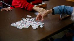 Seniors play dominos at Little Havana Activities and Nutrition Centers of Dade County, Inc., on Wednesday, March 4, 2020, in Miami. (AP Photo/Brynn Anderson)