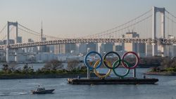TOKYO, JAPAN - MARCH 25: A police boat passes the Tokyo 2020 Olympic Rings on March 25, 2020 in Tokyo, Japan. Following yesterdays announcement that the Tokyo 2020 Olympics will be postponed to 2021 because of the ongoing Covid-19 coronavirus pandemic, IOC officials have said they hope to confirm a new Olympics date as soon as possible. (Photo by Carl Court/Getty Images)