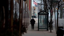 A woman walks alone in an empty street in Detroit, Michigan on March, 24, 2020. - At 12:01 am Tuesday March 24,2020 Governor Gretchen Whitmer ordered a 'Stay at Home and Stay Safe Order' to slow the spread of Coronavirus (COVID-19) across the State of Michigan which now has 1,791 confirmed cases and 24 deaths due to the virus. (Photo by Seth Herald/AFP/Getty Images)