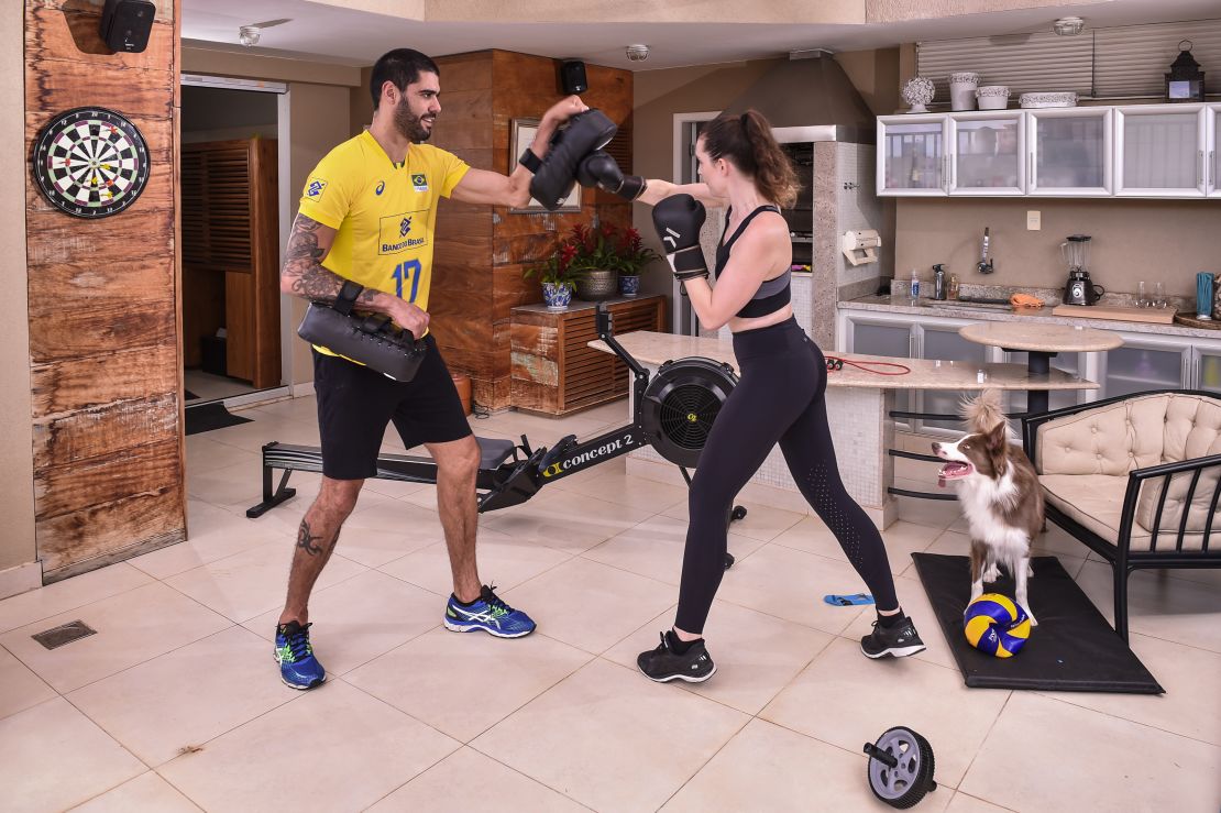 Evandro Guerra, player of the national Brazilian volleyball squad,  trains in his home with his wife.