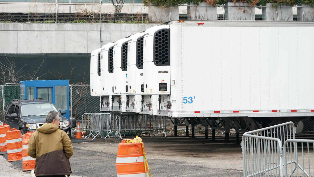 Refrigeration trucks are in place as workers build a makeshift morgue outside of Bellevue Hospital to handle an expected surge in coronavirus victims on March 25 in New York. 