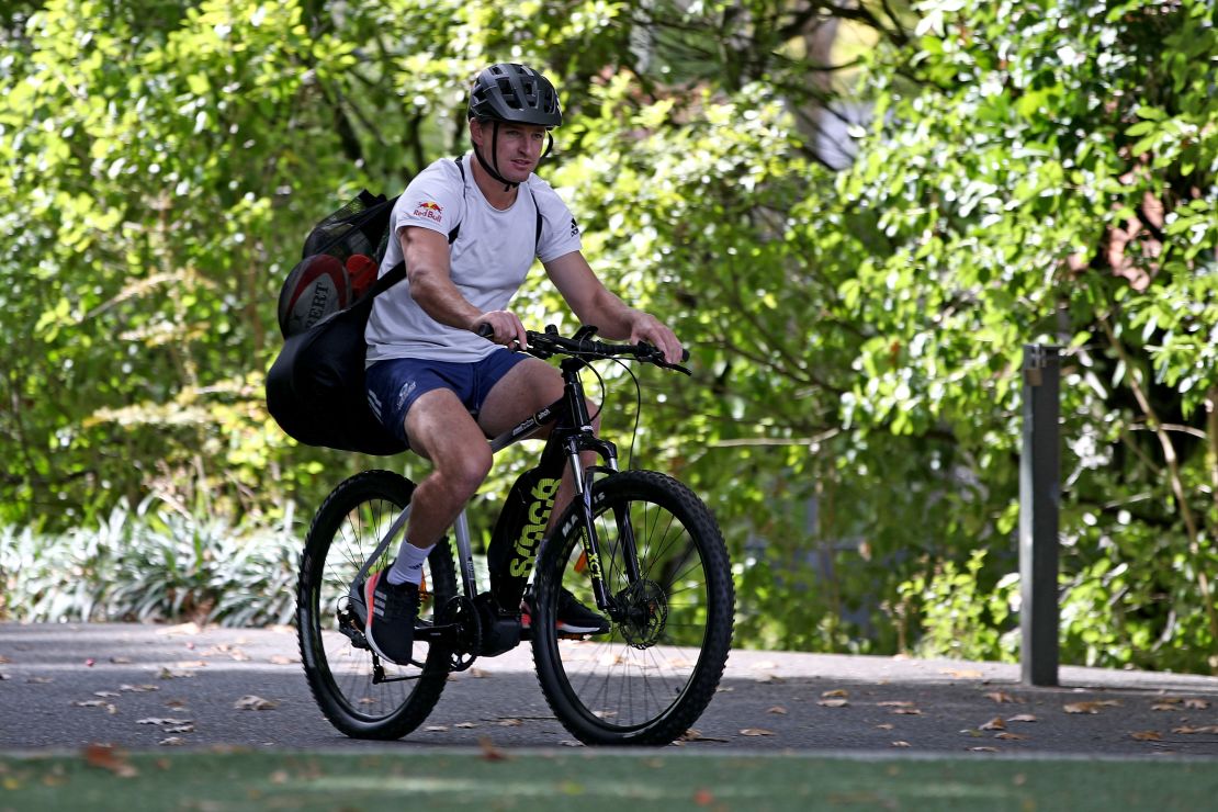 New Zealand rugby player Beauden Barrett arrives on his bike for kicking training in isolation.
