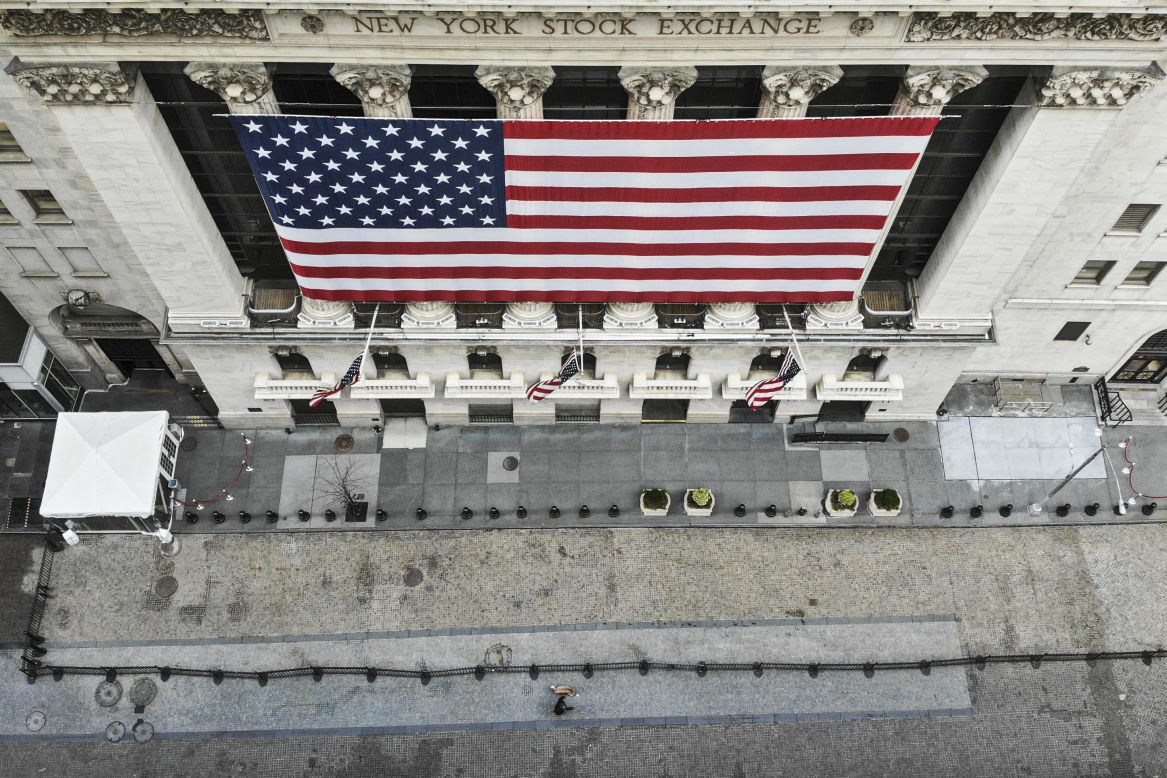 A lone pedestrian walks his dog past the New York Stock Exchange on Saturday, March 21. Because of the coronavirus, the stock exchange <a href="https://www.cnn.com/2020/03/18/investing/nyse-electronic-trading-coronavirus/index.html" target="_blank">has closed its trading floor</a> and moved to electronic trading. <a href="http://www.cnn.com/2020/03/12/world/gallery/coronavirus-empty-spaces/index.html" target="_blank">In pictures: Empty spaces across the globe</a>
