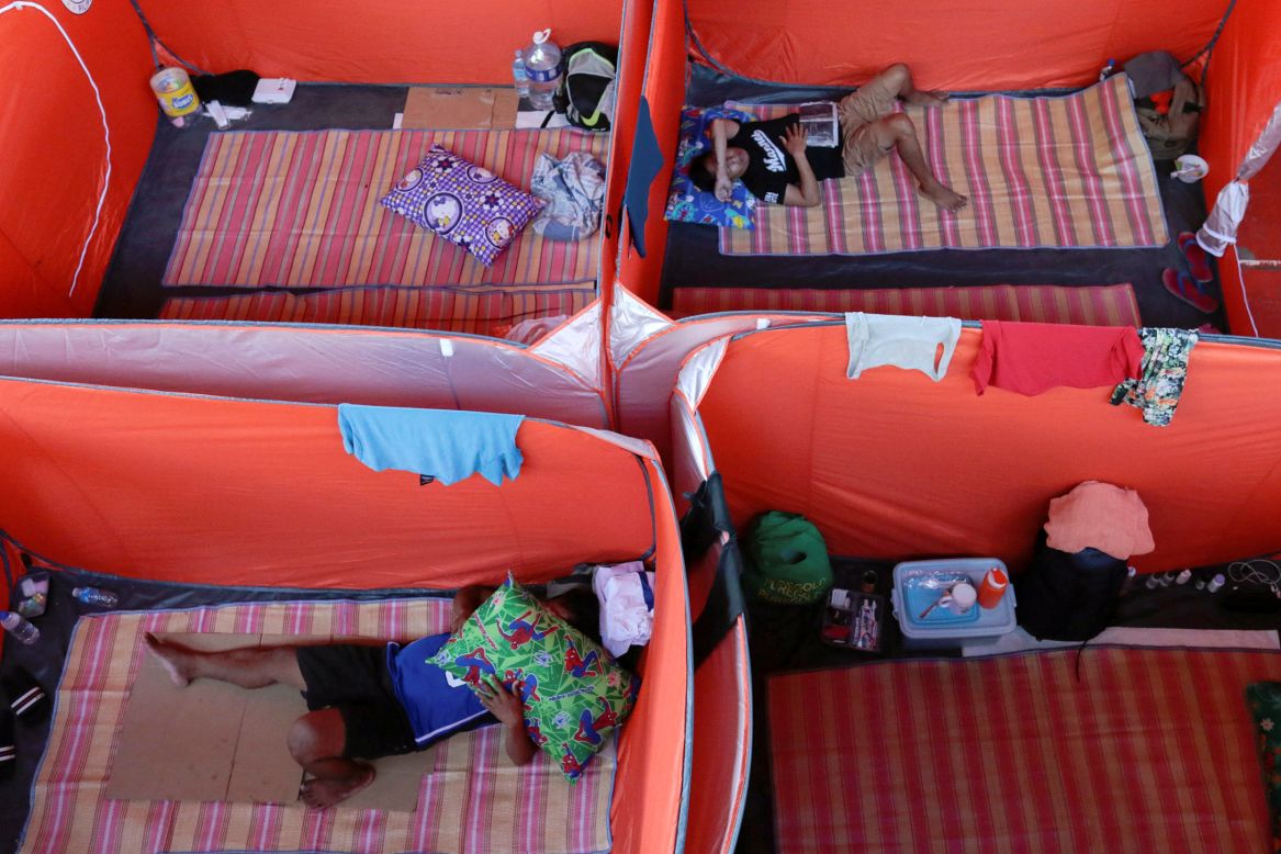 Street dwellers in Manila, Philippines, rest in tents set up as a makeshift evacuation center on Monday, March 23.