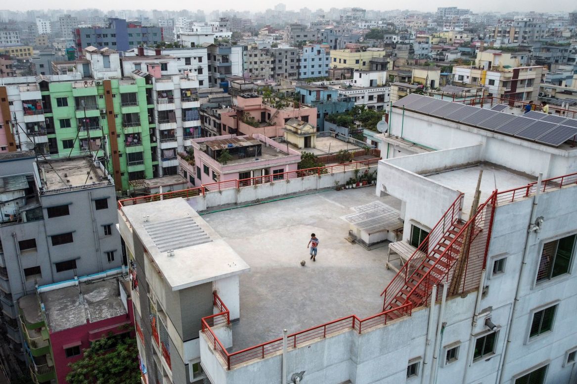 Samin Sharar plays on the rooftop of his building in Dhaka, Bangladesh, instead of going out on Monday, March 23.