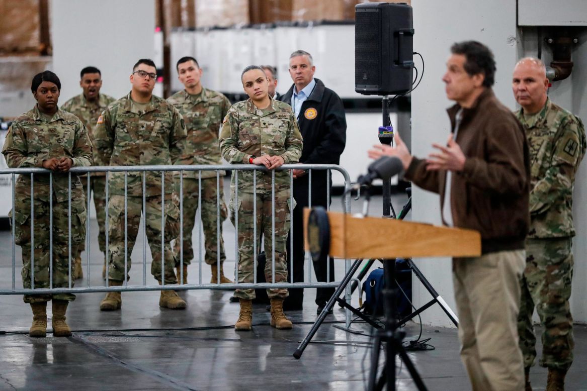 Members of the National Guard watch New York Gov. Andrew Cuomo speak about the coronavirus during a news conference in New York City on Monday, March 23.