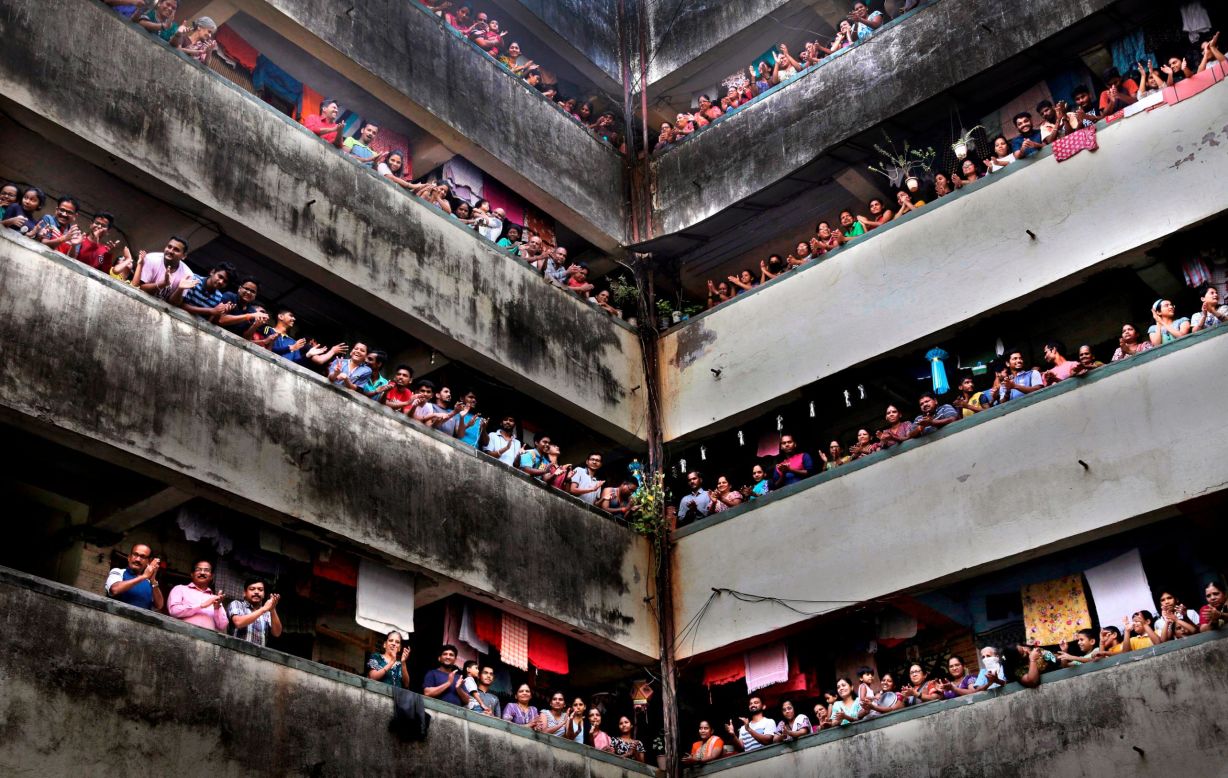 People clap from balconies to show their appreciation for health care workers in Mumbai, India, on Sunday, March 22.