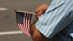 An undocumented immigrant holds an American flag, displaying his love for a country that doesn't love him at an immigration protest in Philadelphia, Pa on June 30, 2018. (Photo by Cory Clark/NurPhoto via Getty Images)