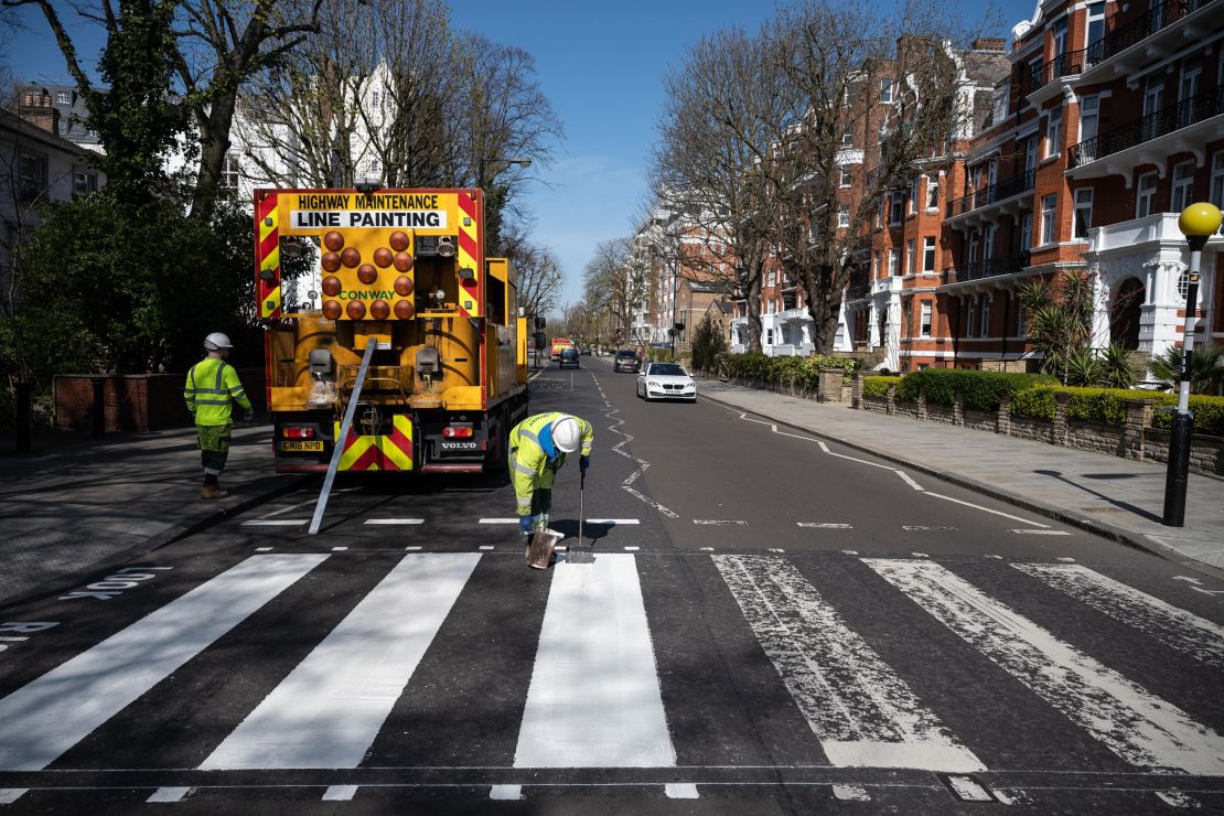 A Highways Maintenance team takes advantage of the COVID-19 coronavirus lockdown to re-paint the iconic Abbey Road crossing in London. 