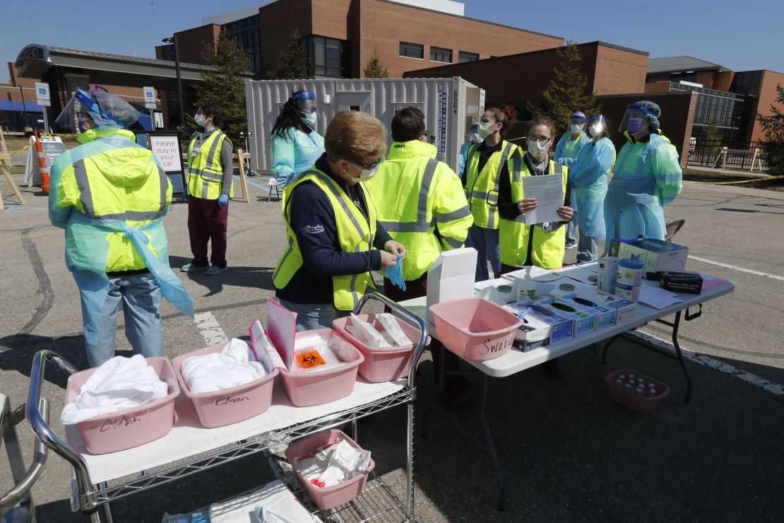 Health care workers prepare their supplies Wednesday at a coronavirus drive-thru testing site at Michigan's Henry Ford West Bloomfield Hospital.