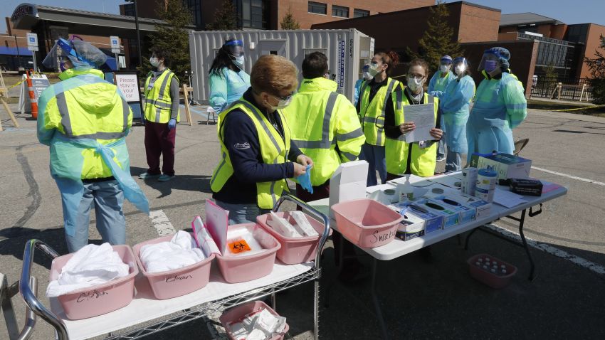 Healthcare workers prepare their supplies at a COVID-19 drive-thru testing site at Henry Ford West Bloomfield Hospital, Wednesday, March 25, 2020, in West Bloomfield, Mich. (AP Photo/Carlos Osorio)
