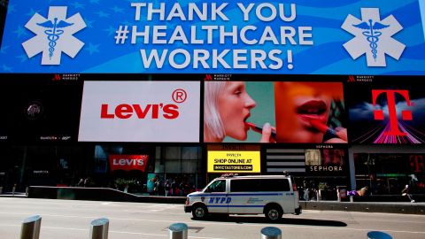 A police van is seen under a sign thanking healthcare workers in Times Square on March 22, 2020 in New York City. 