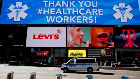 A police van is seen under a sign thanking healthcare workers in Times Square on March 22, 2020 in New York City.