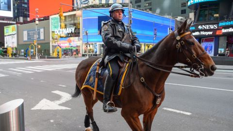 NEW YORK, NY - MARCH 22: An NYPD police officer is seen in Times Square hours ahead of the implementation of "New York State on PAUSE" executive order as the coronavirus continues to spread across the United States.