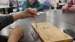 BILLERICA, MA - MARCH 11: A group plays cribbage at the Billlerica Senior Center in Billerica, MA on March 12, 2020. Some seniors and volunteers are helping to wipe down doorknobs, railings and computers. The center has made efforts to keep people informed on the coronavirus. (Photo by Jonathan Wiggs/The Boston Globe via Getty Images)