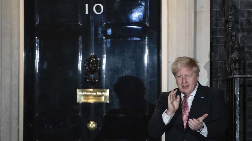 In this  Thursday March 26, 2020 photo Britain's Prime Minister Boris Johnson outside 10 Downing Street in London as he joins a national applause to salute the health service (NHS) workers, in London. British Prime Minister Boris Johnson has tested positive for the new coronavirus . (Aaron Chown/PA via AP)