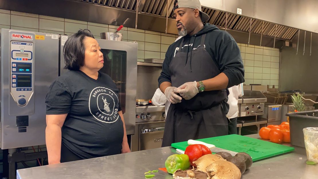 Genevieve Vang of Bangkok 96 Street Food and Maxcel Hardy of Coop Caribbean Fusion discuss plans for the day's menu.