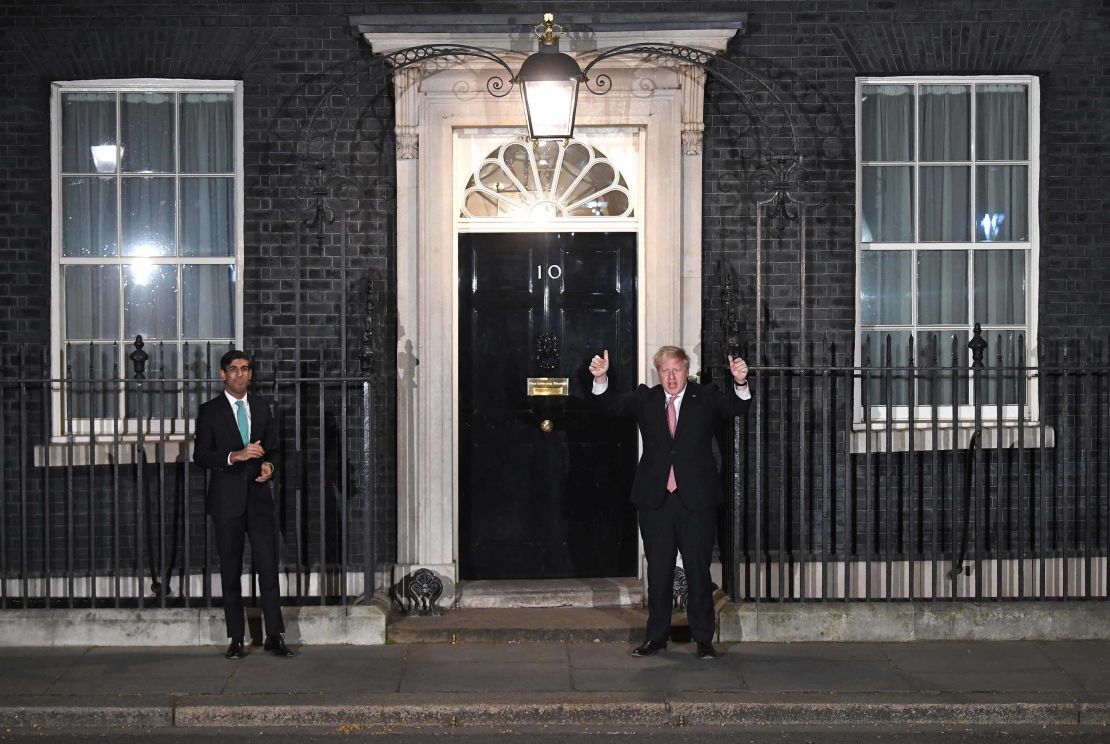 Boris Johnson, right, standing at a distance from his finance minister, Rishi Sunak, on Thursday evening.