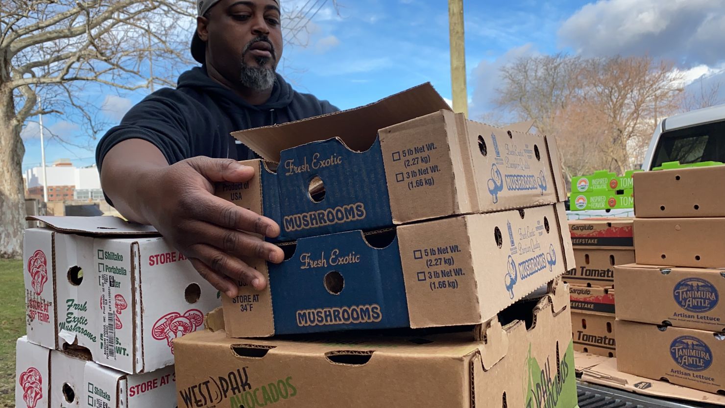 Chef Maxcel Hardy moves boxes of perishable food donated to the "Too Many Cooks in The Kitchen For Good" program.