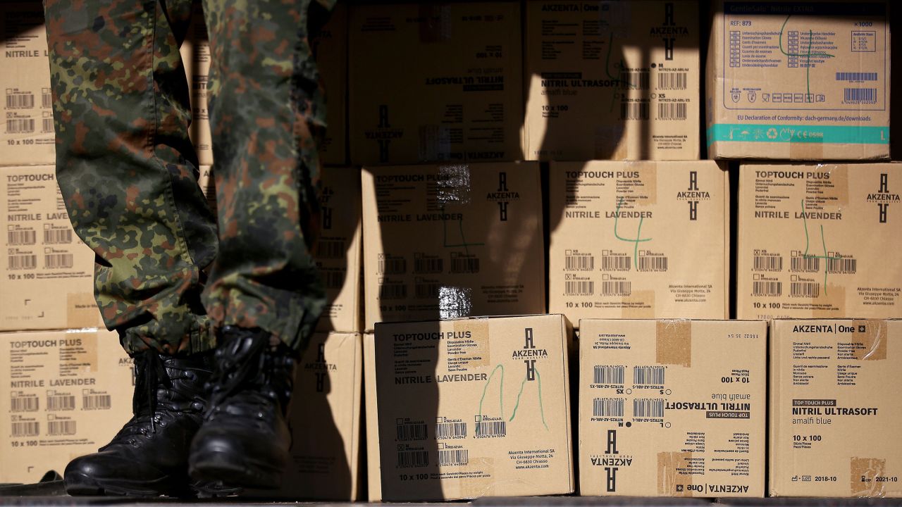 Soldiers from the German army's logistics battalion load protective medical equipment into an army vehicle in Magdeburg, eastern Germany, on March 25, 2020. - Protective equipment like masks, surgical golves and hasardous material suits will be distributed to public health departments in the area to combat the spread of the Covid-19, Coronavirus. (Photo by Ronny Hartmann/AFP/Getty Images)