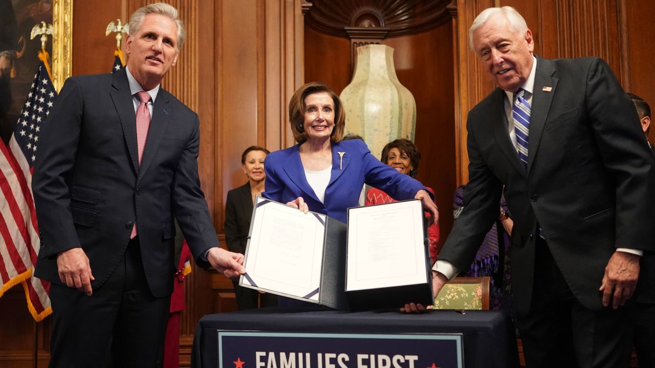 US Speaker of the House Nancy Pelosi (C) and Representatives Kevin McCarthy (L) and Steny Hoyer show the bill to the press after the House passed a $2 trillion stimulus bill, on March 27, 2020, at the US Capitol in Washington, DC - The House approved by a voice vote a $2.2 trillion rescue package, the largest economic stimulus package in American history, to aid a US economy and health care system battered by the coronavirus pandemic. (Photo by ALEX EDELMAN / AFP) (Photo by ALEX EDELMAN/AFP via Getty Images)