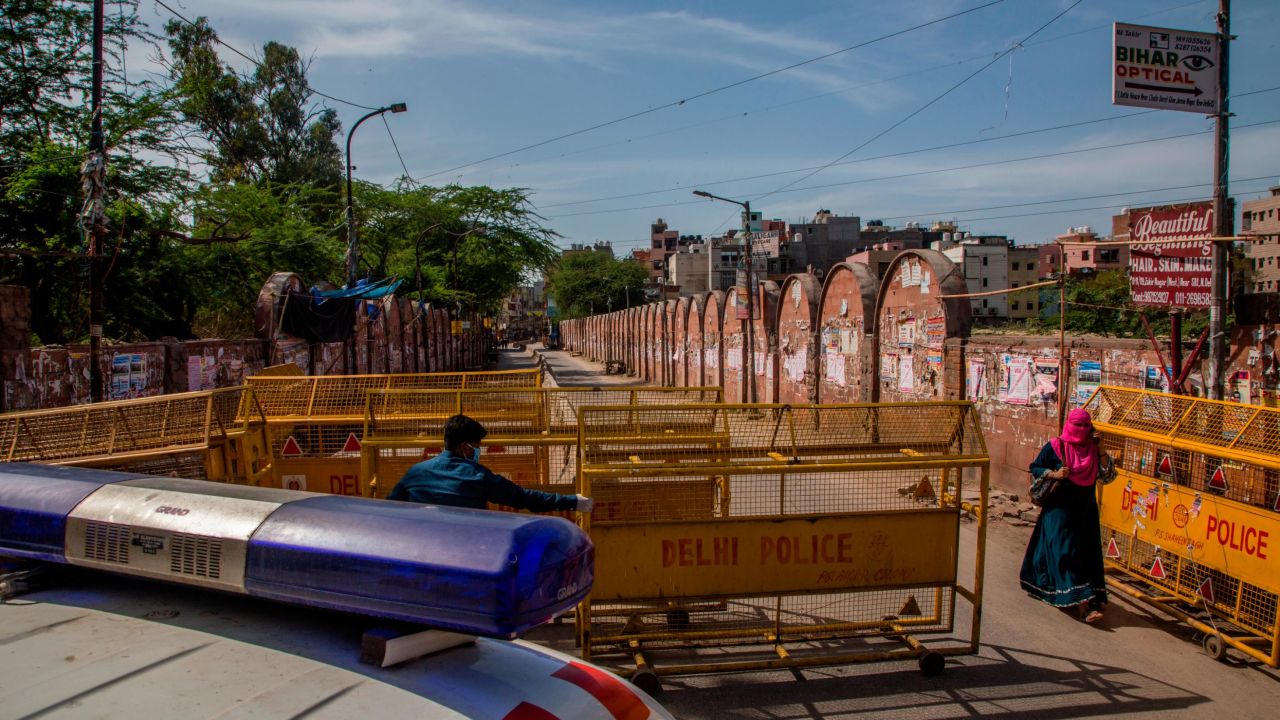 A health worker pulls a barrier aside to give way to an ambulance during the nationwide lockdown on March 25 in New Delhi.
