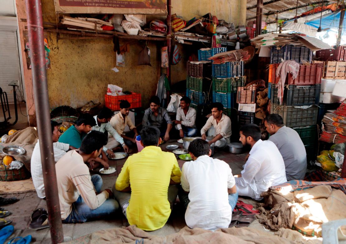 Vendors eat a meal at a wholesale market in Mumbai, India on March 24, one day before the nationwide lockdown.
