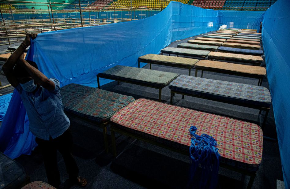 A worker fixes partitions at a quarantine center in Guwahati, India, on March 28, 2020.