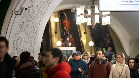 In this photo taken on  Feb. 22, a surveillance camera, top left, is seen as people walk down in a Moscow's Metro. 
