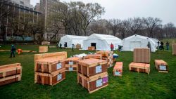 A Samaritan's Purse crew works on building an emergency field hospital equipped with a respiratory unit in New York's Central Park across from the Mount Sinai Hospital, Sunday, March 29, 2020. (AP Photo/Mary Altaffer)
